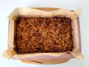 Baked granola cooling in the tin