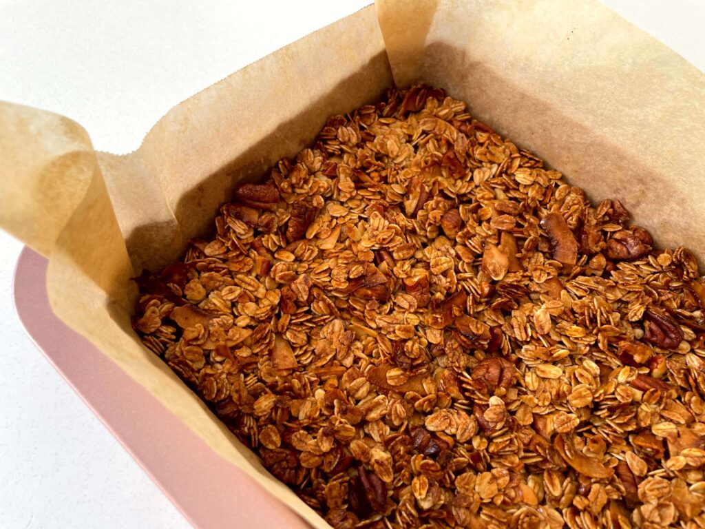 Baked granola cooling in the tin