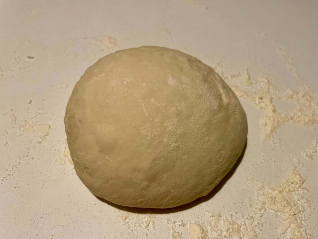 Bread dough after folding and forming into a neat ball