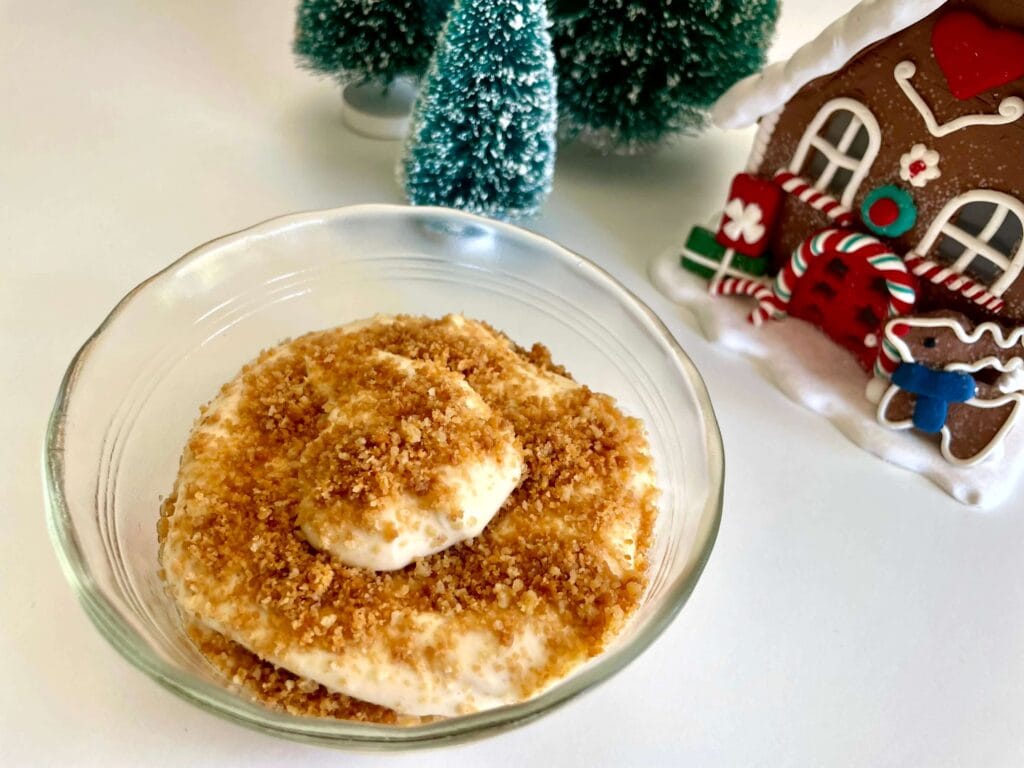Eggnog cheesecake parfait with Christmas decorations in the background