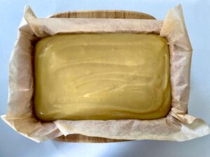 The caramel has been poured over the biscuit base and is ready to be cooked