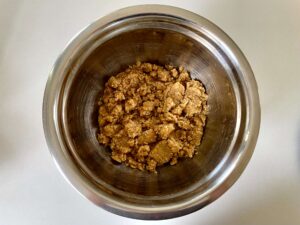 Flour, brown sugar, desiccated coconut, and butter mixed together to form a moist crumble mixture