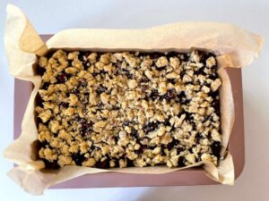 Chopped cherries and cinnamon walnut crumble mixture spread evenly over the base