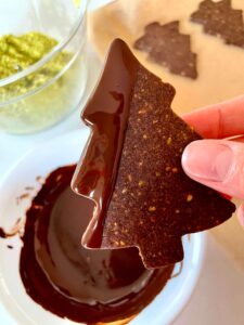 Chocolate pistachio Christmas tree cookie dipped in chocolate