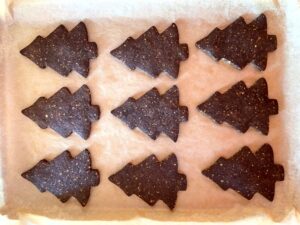 Baked chocolate pistachio Christmas tree cookies ready to be decorated