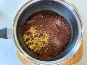 Cocoa powder and ground pistachios added to the butter mixture