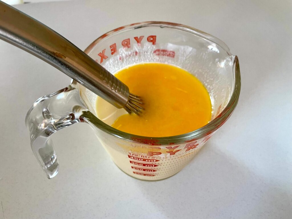 Melted butter poured into a mixture of buttermilk and egg