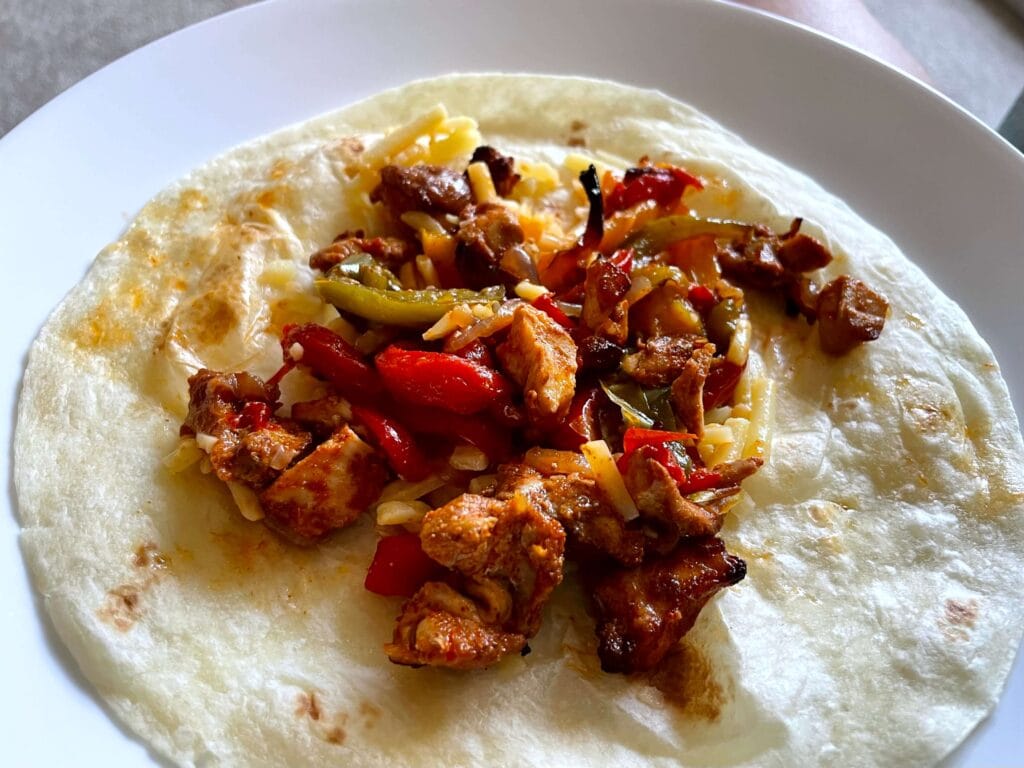 Fajita Mixture on a Warm Tortilla with Shredded Cheese