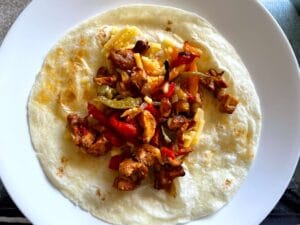 Fajita Mixture on a Warm Tortilla with Shredded Cheese