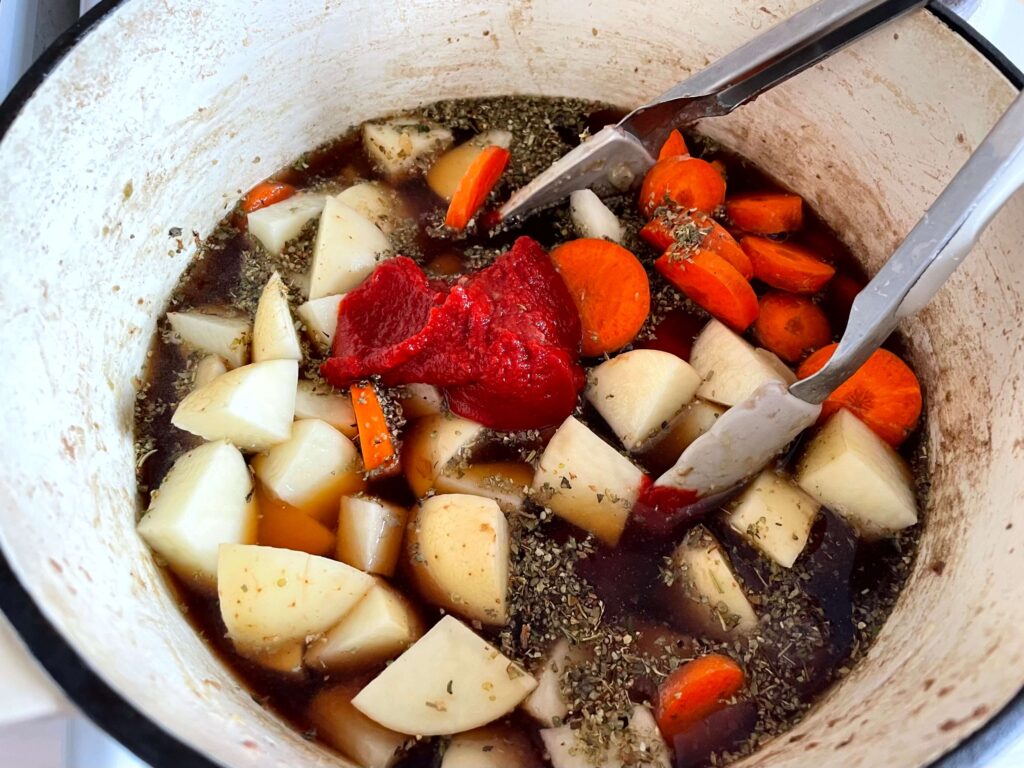 Vegetables, Seasonings, and Stock Added to the Dutch Oven