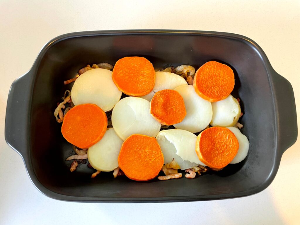 Layers of Bacon-Onion Mixture and Sliced Potatoes