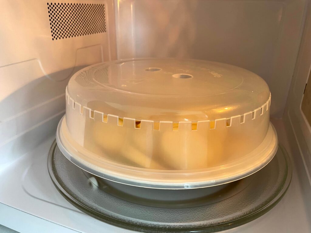 Sliced Potatoes Cooking in the Microwave